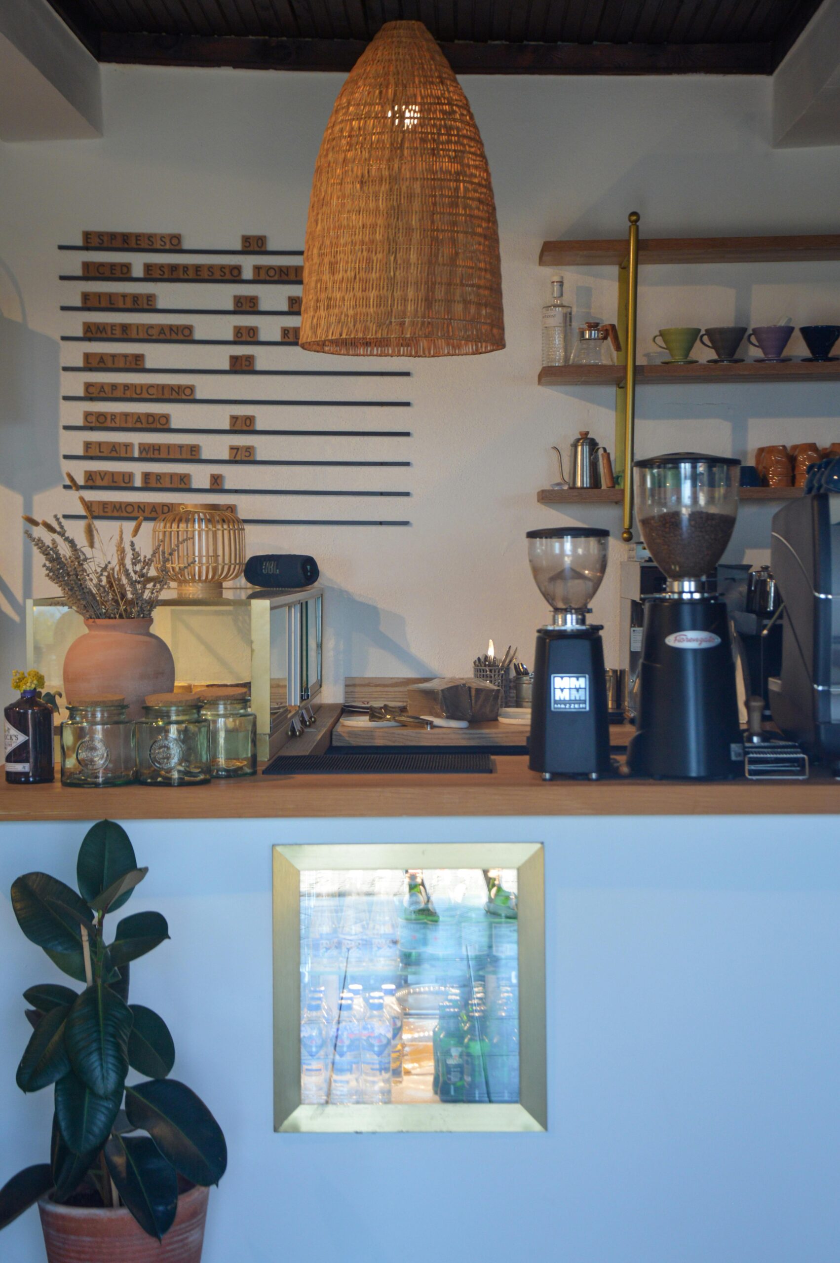 Warm and inviting café interior in Çanakkale featuring coffee equipment and decoration.